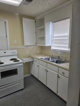a kitchen that has a sink and a stove