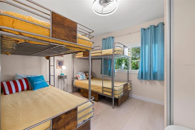 a bedroom with furniture and a large window