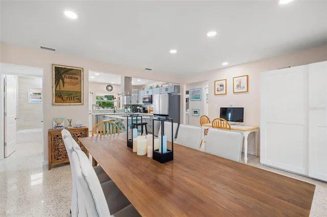 a dining room with furniture and wooden floor