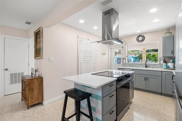 a kitchen with granite countertop a stove and a refrigerator