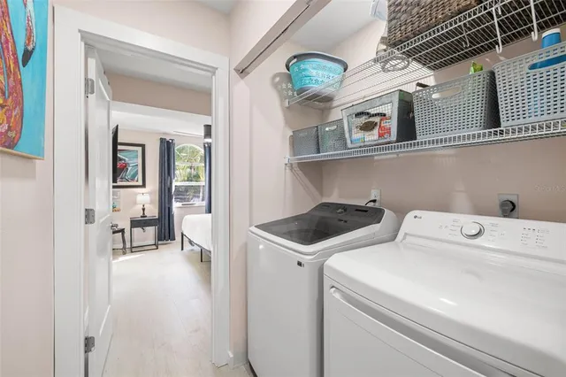 a view of washer and dryer with kitchen in the background