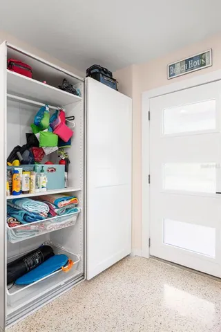 a utility room with lots of different colored cloths