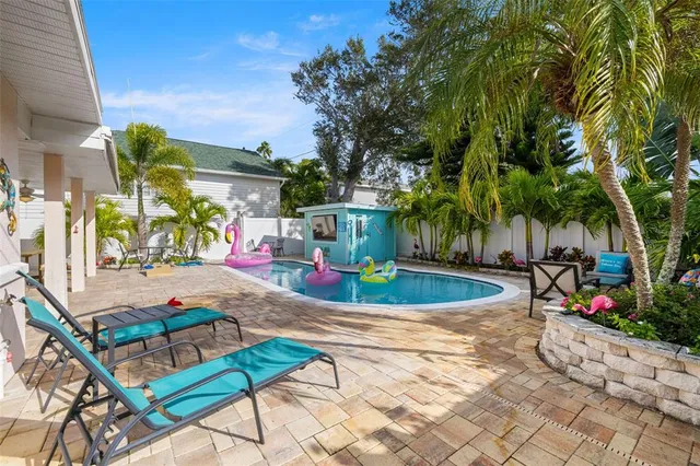 a backyard of a house with table and chairs