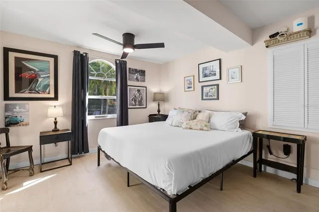 a bedroom with a bed a desk and chair with a bookshelf