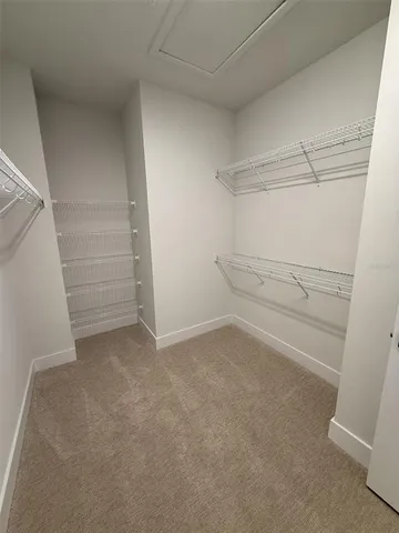 a spacious bathroom with double sink and a mirror