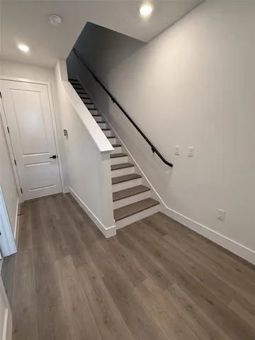 a view of entryway and hall with wooden floor