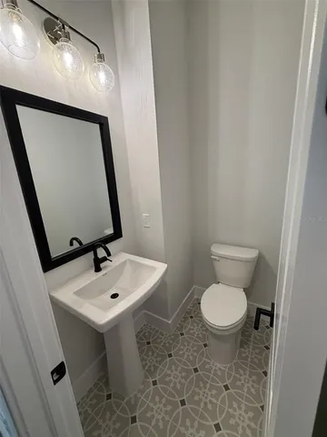 a large kitchen with kitchen island a large counter top stainless steel appliances and cabinets