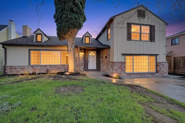 a front view of a house with a yard