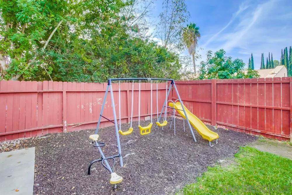13502 Carriage Road Poway, CA 92064 - Photo 40 of 45 a view of a backyard with a slide and potted plants