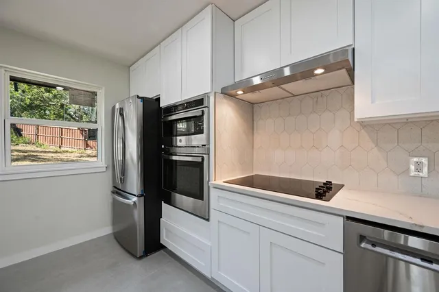 a kitchen with a refrigerator and a sink