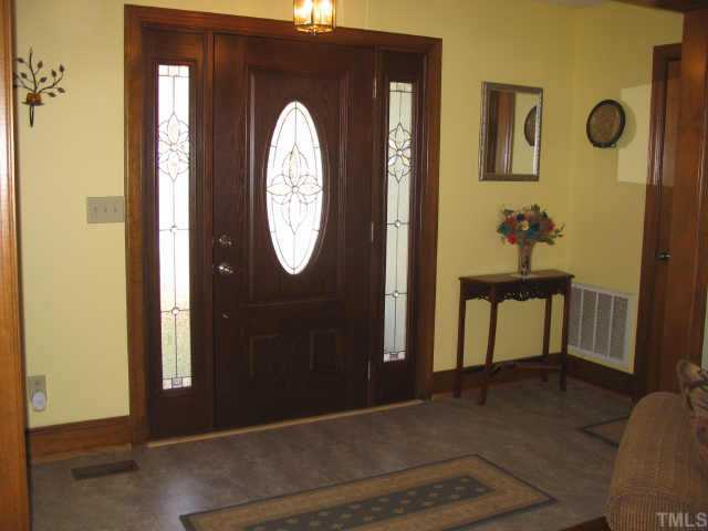 7505 Old Fox Trail Raleigh, NC 27613 - Photo 5 of 12 New High Quality Exterior Doors. New Durastone Floors In Foyer & Hallways