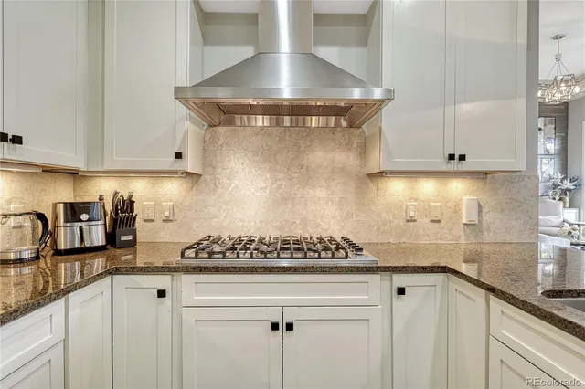 a kitchen with a stove and cabinets