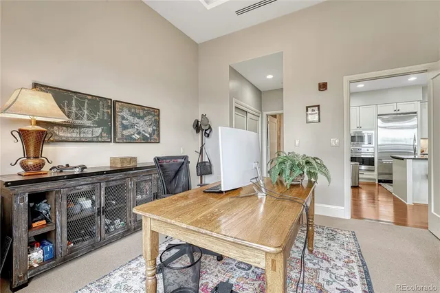 a kitchen with a stove a refrigerator and wooden floor