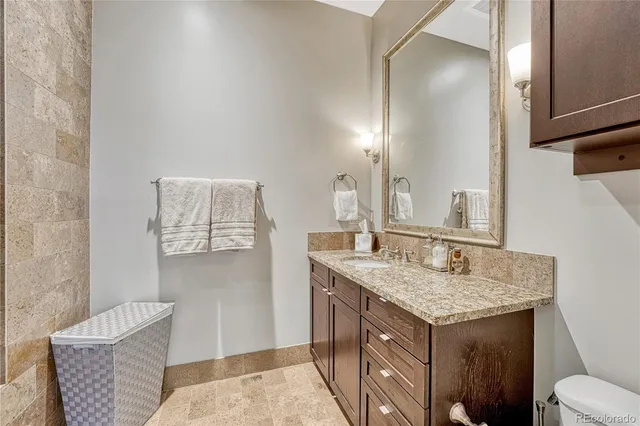 a bathroom with a granite countertop sink and a mirror