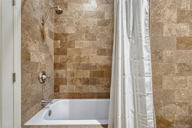 a bath tub sitting next to a shower