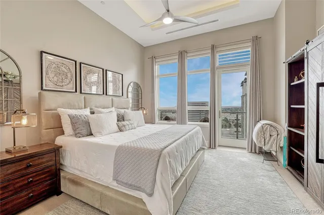 a spacious bedroom with a bed and a large window