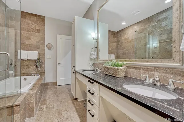 a bathroom with double vanity sinks double vanity shower and a bathtub