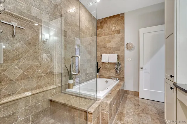 a bathroom with a bathtub and shower