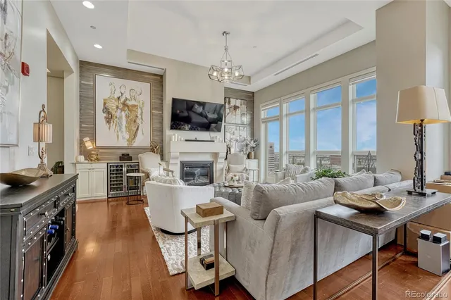 a living room with fireplace furniture and a flat screen tv