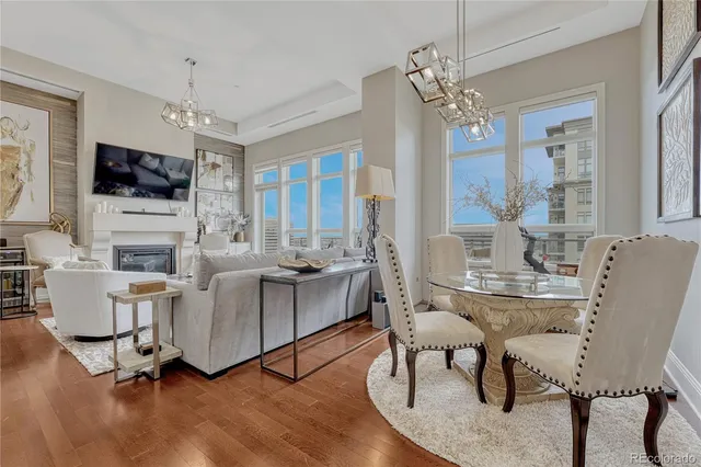 a living room with furniture a flat screen tv and a large window
