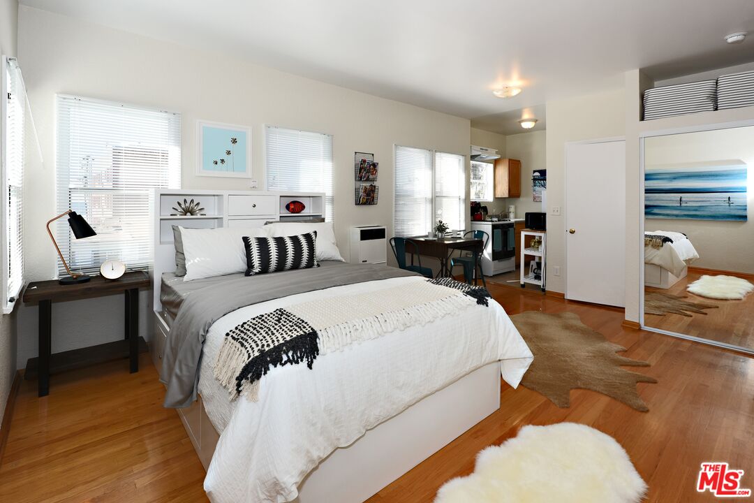 a bedroom with a bed and wooden floor