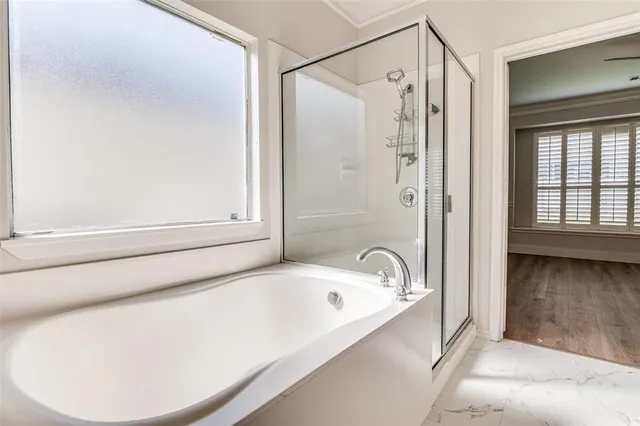 a bathroom with a tub and a shower