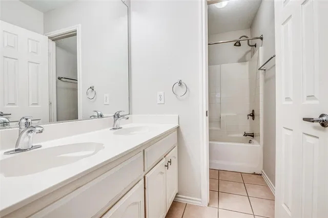 a room with white cabinets and a window