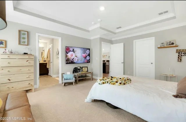 a bedroom with a bed and a couch