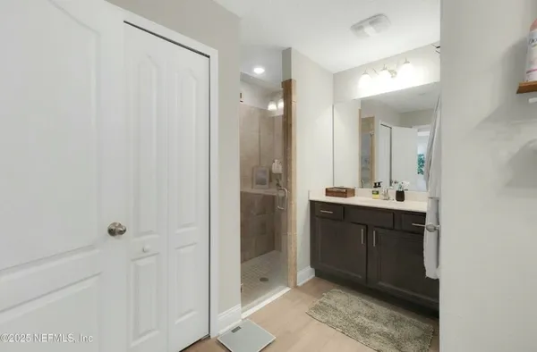 a bathroom with a sink vanity and mirror