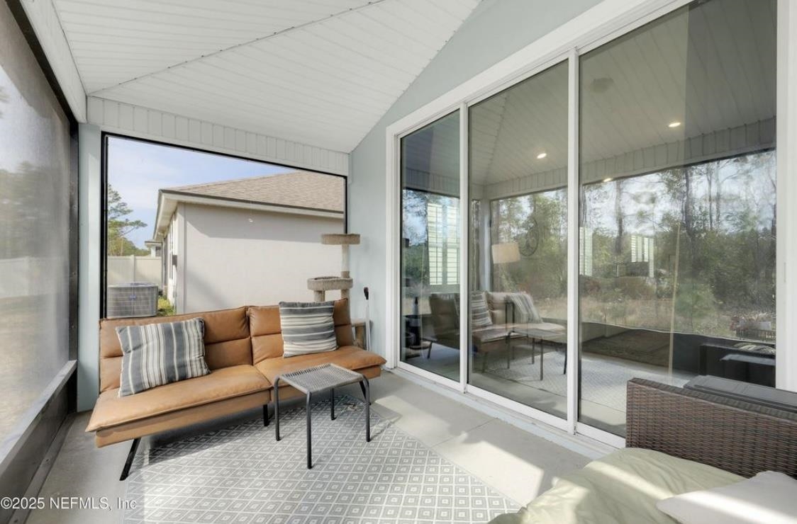49 Narvarez Avenue St. Augustine, FL 32084 - Photo 15 of 17 a living room with furniture and a glass door