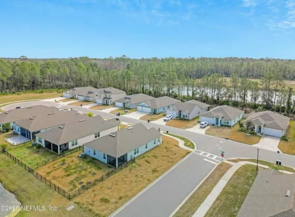 a living room with furniture and a glass door