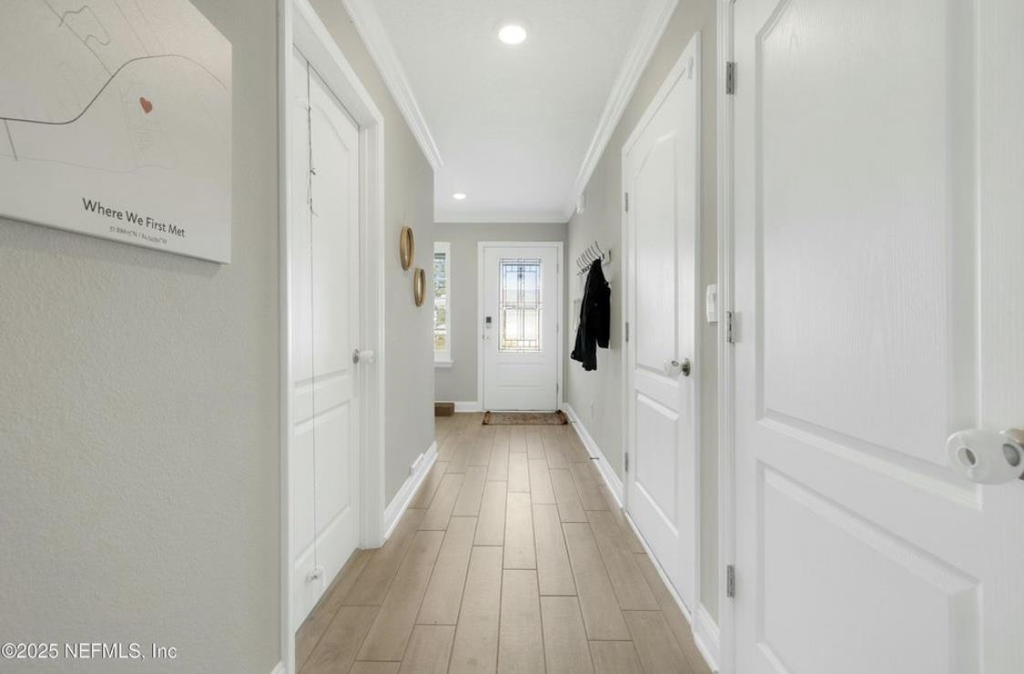 49 Narvarez Avenue St. Augustine, FL 32084 - Photo 2 of 17 a view of a hallway with wooden floor and staircase