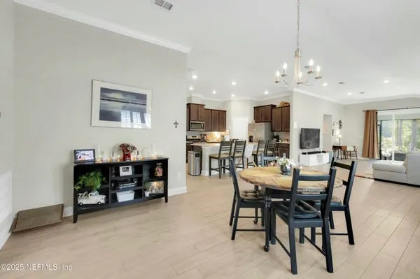 a view of a dining room with furniture and a kitchen