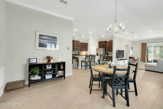 a view of a dining room with furniture and a kitchen