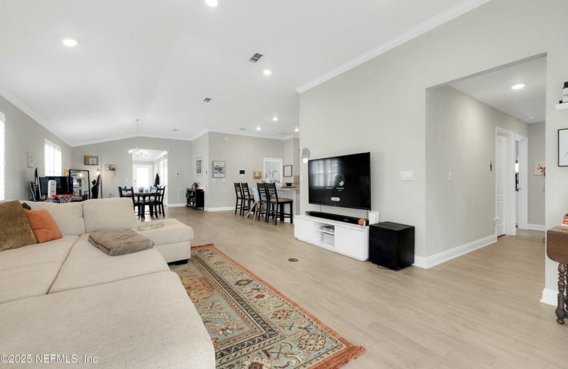49 Narvarez Avenue St. Augustine, FL 32084 - Photo 7 of 17 a living room with furniture a flat screen tv and kitchen view