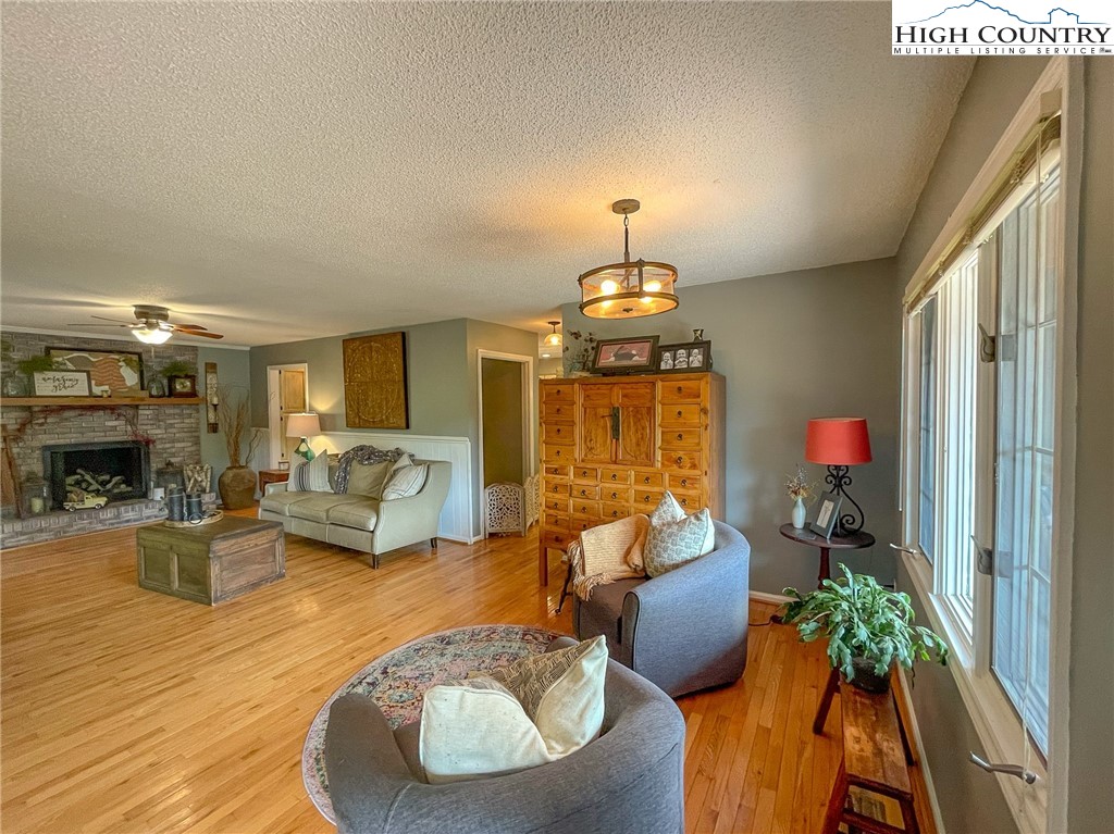 4850 US Highway 421 Vilas, NC 28692 - Photo 16 of 46 a living room with furniture chandelier and a fireplace