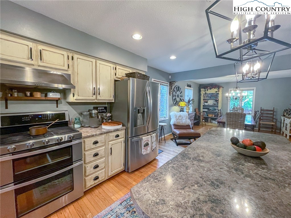 4850 US Highway 421 Vilas, NC 28692 - Photo 17 of 46 a kitchen with stove a refrigerator and furniture