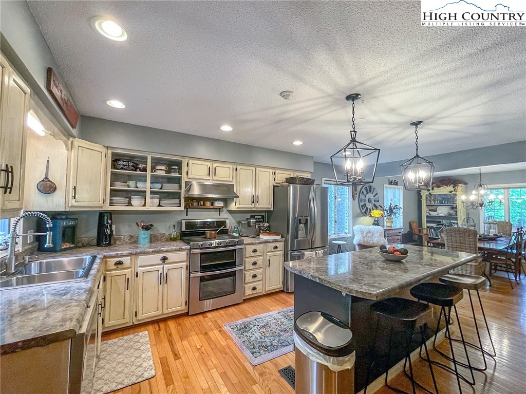 4850 US Highway 421 Vilas, NC 28692 - Photo 18 of 46 a kitchen with stainless steel appliances granite countertop a sink stove and refrigerator