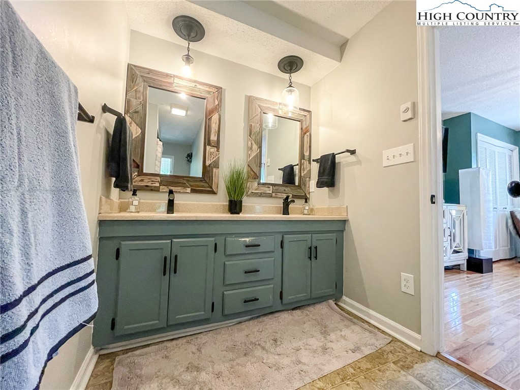 4850 US Highway 421 Vilas, NC 28692 - Photo 29 of 46 a bathroom with a double vanity sink mirror and shower