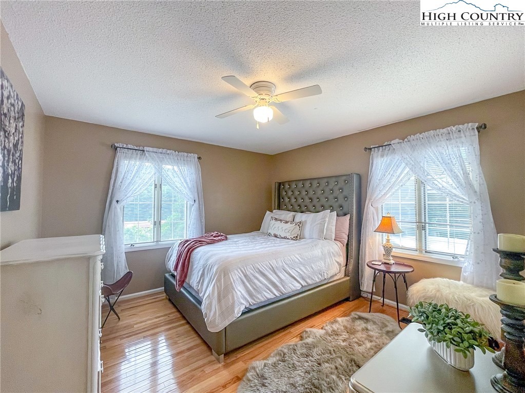 4850 US Highway 421 Vilas, NC 28692 - Photo 30 of 46 a bedroom with a large bed and a chandelier