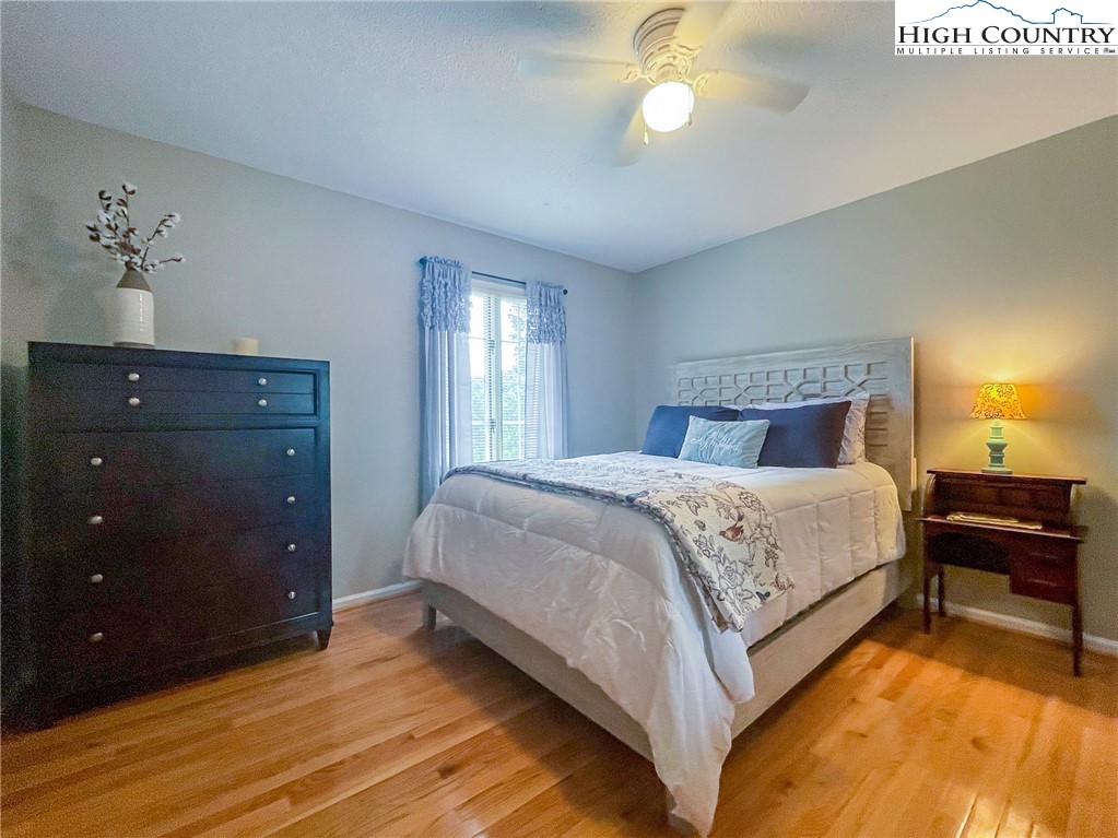 4850 US Highway 421 Vilas, NC 28692 - Photo 33 of 46 a bedroom with a bed and a chandelier