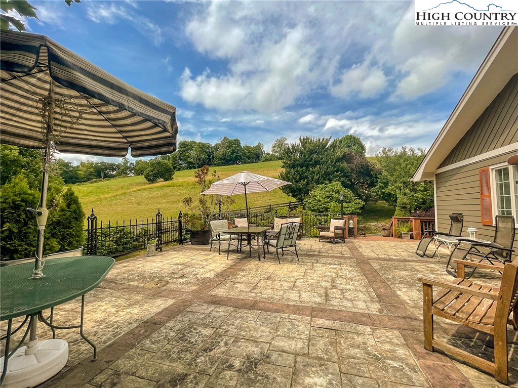4850 US Highway 421 Vilas, NC 28692 - Photo 7 of 46 a view of a patio with a table and chairs under an umbrella