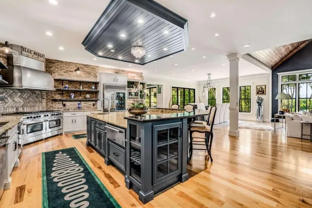 a living room with furniture and a chandelier