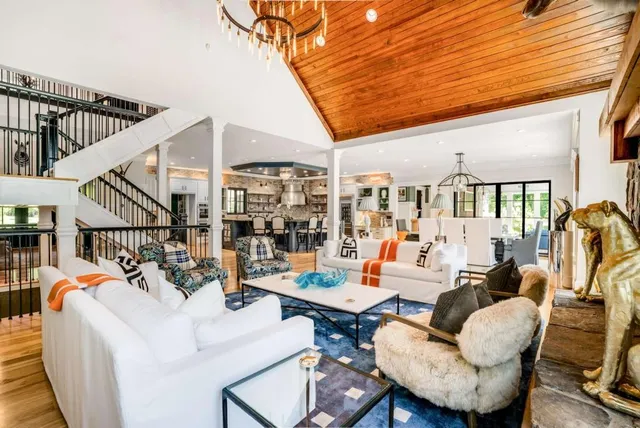 a bedroom with a large bed and a chandelier