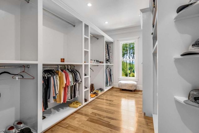 a living room with fireplace furniture and a large window