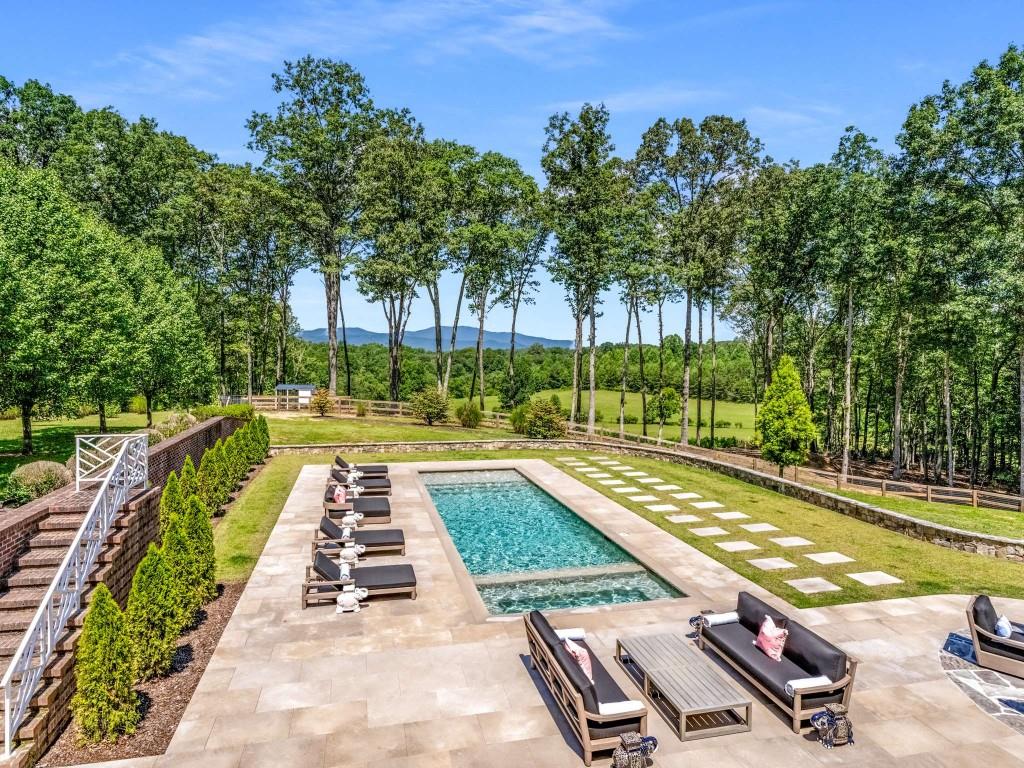 254 Nicholson Road Blue Ridge, GA 30513 - Photo 3 of 86 a view of swimming pool with chairs and trees