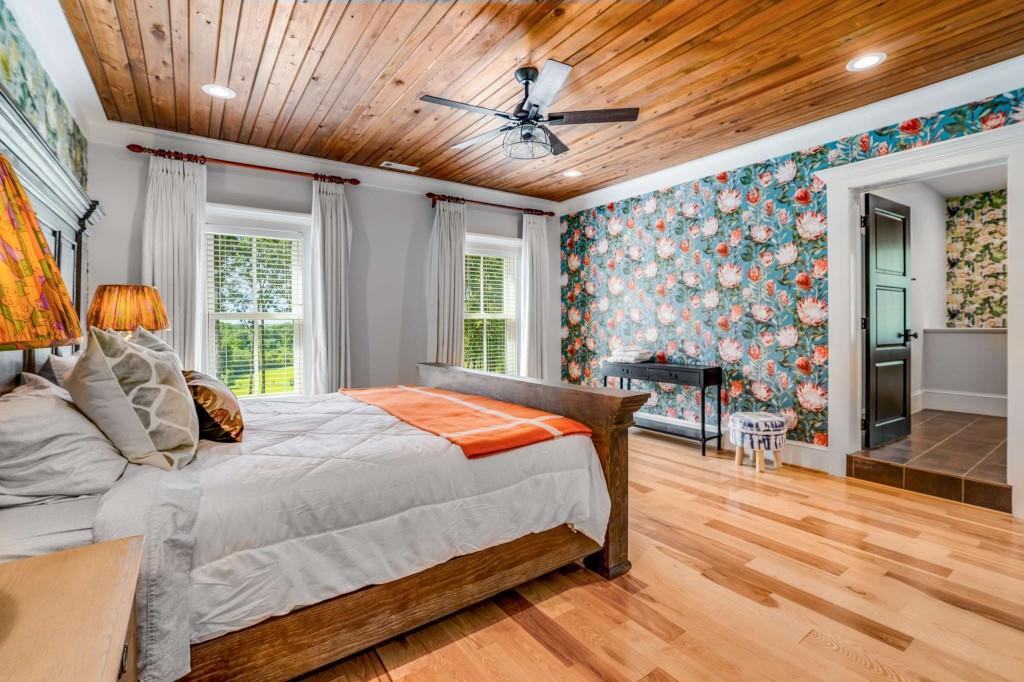 254 Nicholson Road Blue Ridge, GA 30513 - Photo 37 of 86 a bedroom with a large bed and a chandelier