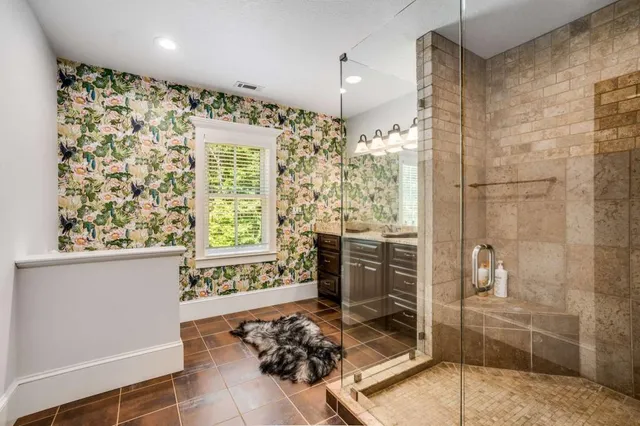 front view of a house with a yard and potted plants