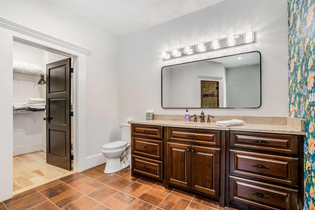 254 Nicholson Road Blue Ridge, GA 30513 - Photo 42 of 86 a spacious bathroom with a double vanity sink a toilet and a mirror