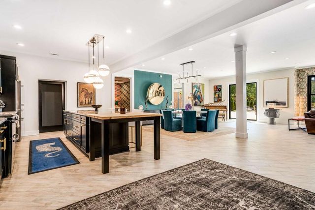 an aerial view of a house with a yard and swimming pool
